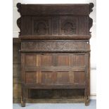 A 17th CENTURY STYLE JOINED OAK TESTER BED, all over carved with arcaded panels & foliate friezes,
