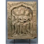 An Indian terracotta relief-decorated rectangular tile depicting three dancing figures in an