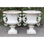 A PAIR OF VICTORIAN CAST-IRON LARGE GARDEN URNS, each with gadrooned edge, classical relief