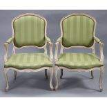 A pair of 20th century open armchairs/fauteuil in the Louis XVI style, having bleached carved