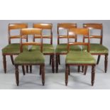 A set of six George IV mahogany dining chairs with open bow-backs, padded seats & turned & fluted