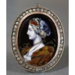 A 19th century Limoges enamel oval pendant painted with the bust of a noblewoman in the
