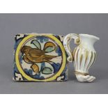 An early pottery tile fragment, with polychrome decoration of a bird in a roundel, 3” x 3¼”; & a