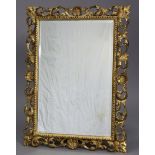 A 19th century Florentine wall mirror with finely carved & pierced giltwood frame inset bevelled