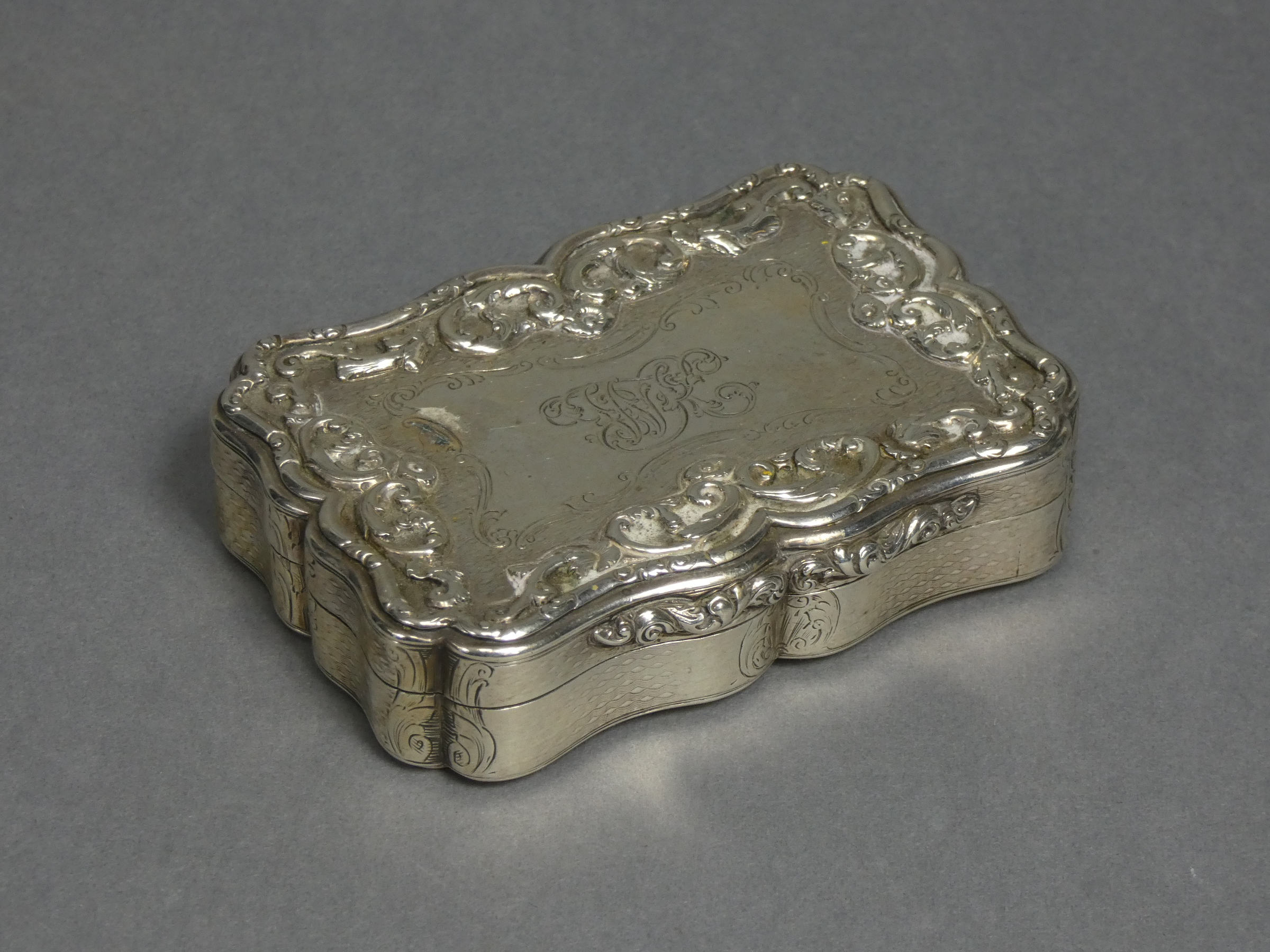 An early Victorian silver presentation large snuff box of rectangular shape with serpentine sides,