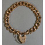 A 9ct. gold curb-link bracelet with padlock clasp & safety chain. (15 gm.)