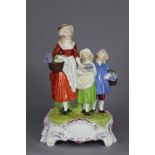 A large Dresden porcelain “Yardley’s” advertising group of a mother & two children carrying