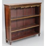 A late Victorian mahogany standing open bookcase, fitted two adjustable shelves, & on short feet;