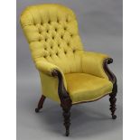 A Victorian mahogany armchair, with tall buttoned back, curved arms, & sprung seat upholstered