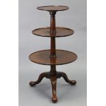 An 18th century mahogany circular three-tier dumb waiter with gun-barrel column, on three cabriole