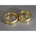 Two 22ct. gold plain bands, one size N. the other with cut shank; total weight: 11.3 gm.