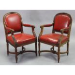 A pair of late Victorian mahogany open armchairs in the Louis XVI style, each with foliate carved