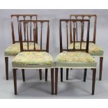 A set of four Sheraton-style mahogany dining chairs with carved decoration to the open splat