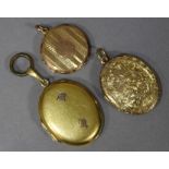 A 9ct. gold circular engine-turned pendant locket; & two un-marked yellow metal oval pendant