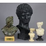 An ebonised resin bust of Antinous, on square base, 12” high; a bronzed composition bust of Apollo