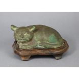 A bronze model of a resting cat, on hardwood base, 6¾” wide x 3½” high over-all.