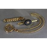 A 15ct. gold circular open-work pendant on un-marked yellow metal curb-link bracelet; a 9ct.