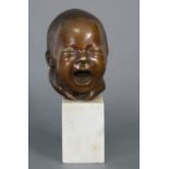 A sculptured bronze bust of an infant, on white marble plinth base; 8½” high over-all.