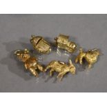 Five 9ct. gold pendant bracelet charms: Teddy bear; Donkey; Poodle; Baby in a wicker crib; & ‘The