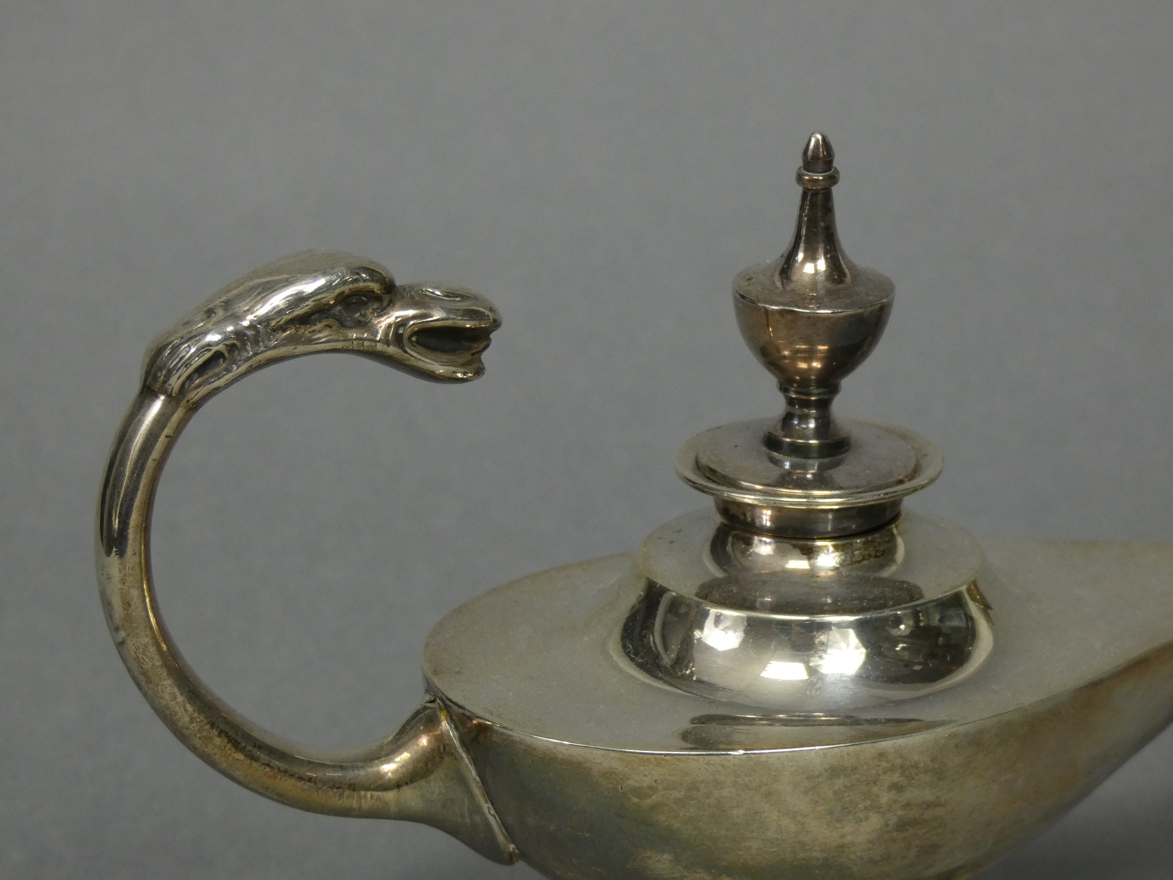 An Edwardian silver table cigar lighter in the form of a roman oil lamp with urn finial & mythical - Image 3 of 4
