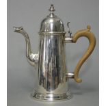 A Queen Anne-style silver coffee pot of round tapered form with wooden scroll handle, 9¼” high,