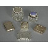 An Edwardian silver rectangular snuff box with engraved scroll decoration, shaped sides, & hinged