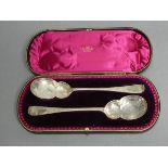 A pair of late Victorian silver serving spoons with gourd-shaped bowls & all-over engraved