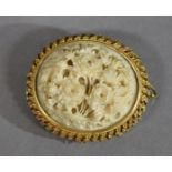 An oriental ivory gold brooch, finely carved as a bouquet, in yellow metal mount with triple pierced