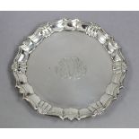 A George II silver waiter with “pie-crust” edge, engraved monogram, & on three pad feet, 6½”