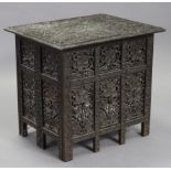 An early 20th century Indian rectangular occasional table, with all-over profusely carved floral dec