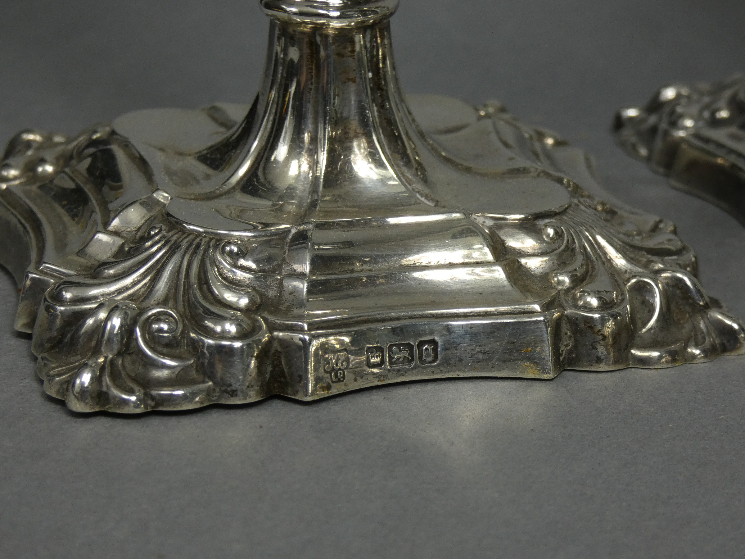 A set of four Edwardian silver candlesticks in the mid-18th century cast style, each with slender - Image 4 of 4