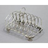 A William IV silver large toast rack of six wire-work kidney-shaped divisions, with centre ring