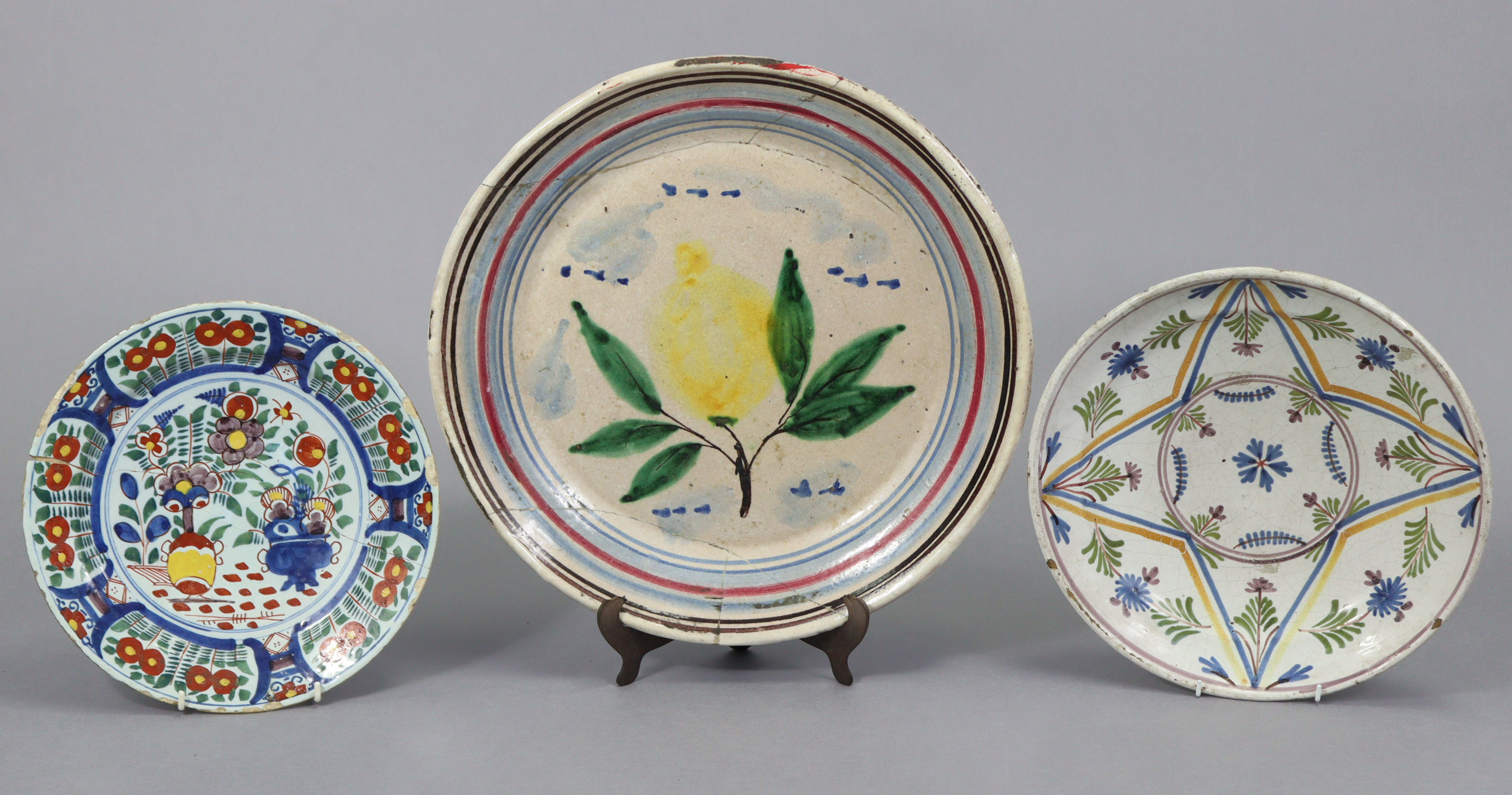 A 19th century French faience shallow bowl with painted floral decoration 12¾” diam.; a similar