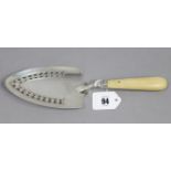 A George III silver fish slice, the pierced spade-shaped blade with engraved family crest, plain