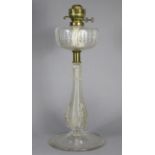 A Victorian large oil lamp with cut-glass reservoir, on ribbed baluster column & circular base