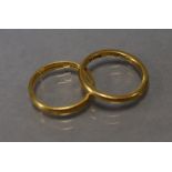 A 22ct. gold wedding band (size: M); & another 22ct. gold wedding band (size: K/L); total weight:
