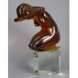LOREDANO ROSIN (1936-1992). A Murano amber glass sculpture of a crouching female nude, on clear