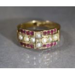 A Victorian 15ct. gold ring set eight seed pearls, four rows of four small rubies, & a tiny