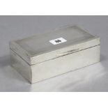 A George V silver cigarette box of rectangular shape, with engine-turned border to the hinged lid,