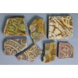 A medieval pottery slip-decorated 4½” square tile (w.a.f.); & six ditto tile fragments.
