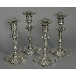 A set of four Edwardian silver candlesticks in the mid-18th century cast style, each with slender