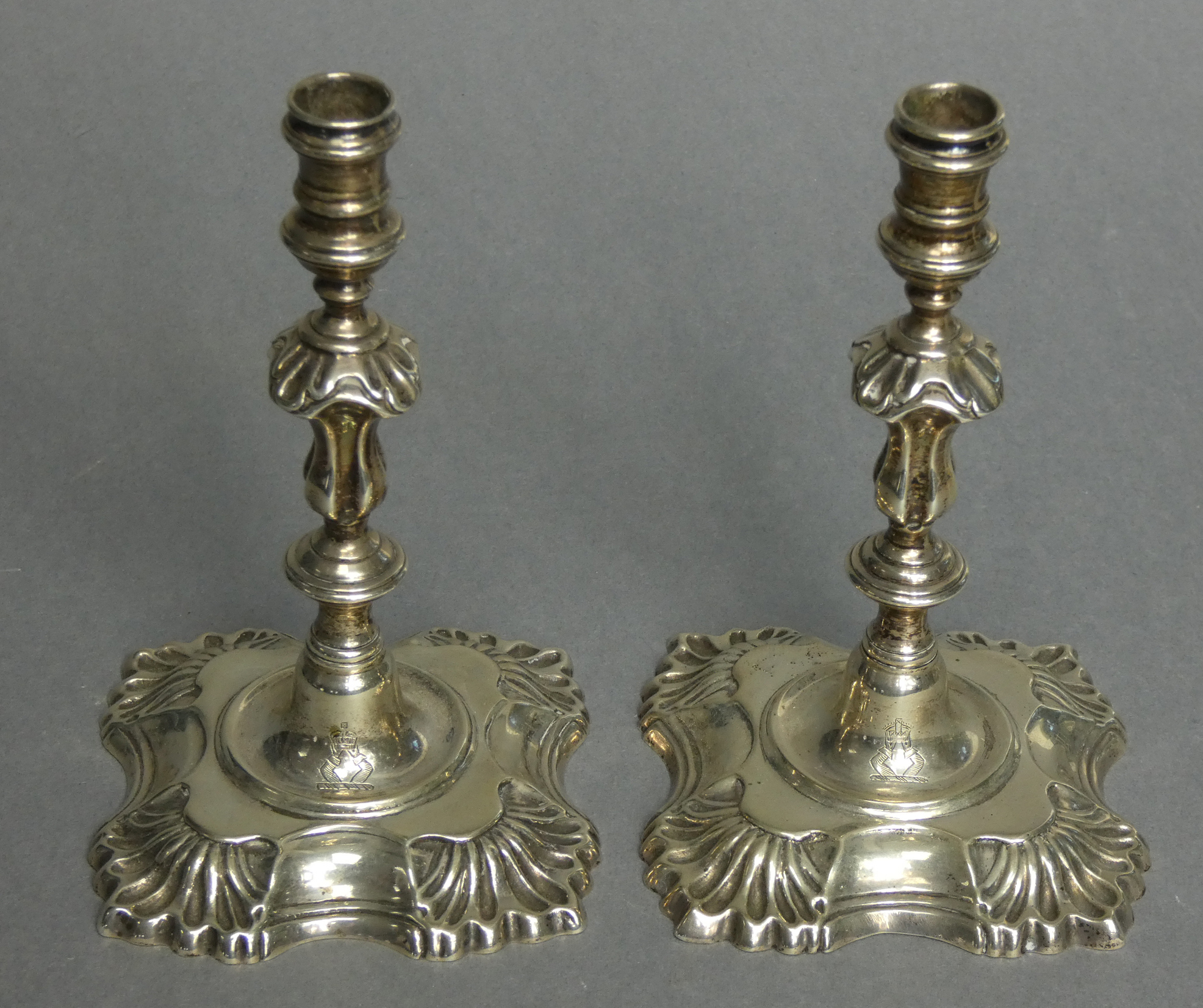 A pair of cast silver tapersticks in the mid-18th century style, with reel-shaped nozzles, slender