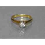 An 18ct. gold ring set single diamond; size: M; weight: 2.5 gm.