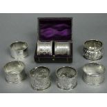 A pair of Victorian silver napkin rings with beaded rims & engraved flower-head & star decoration,