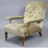 A Victorian walnut easy chair with shaped buttoned back, open arms, & sprung seat upholstered pale