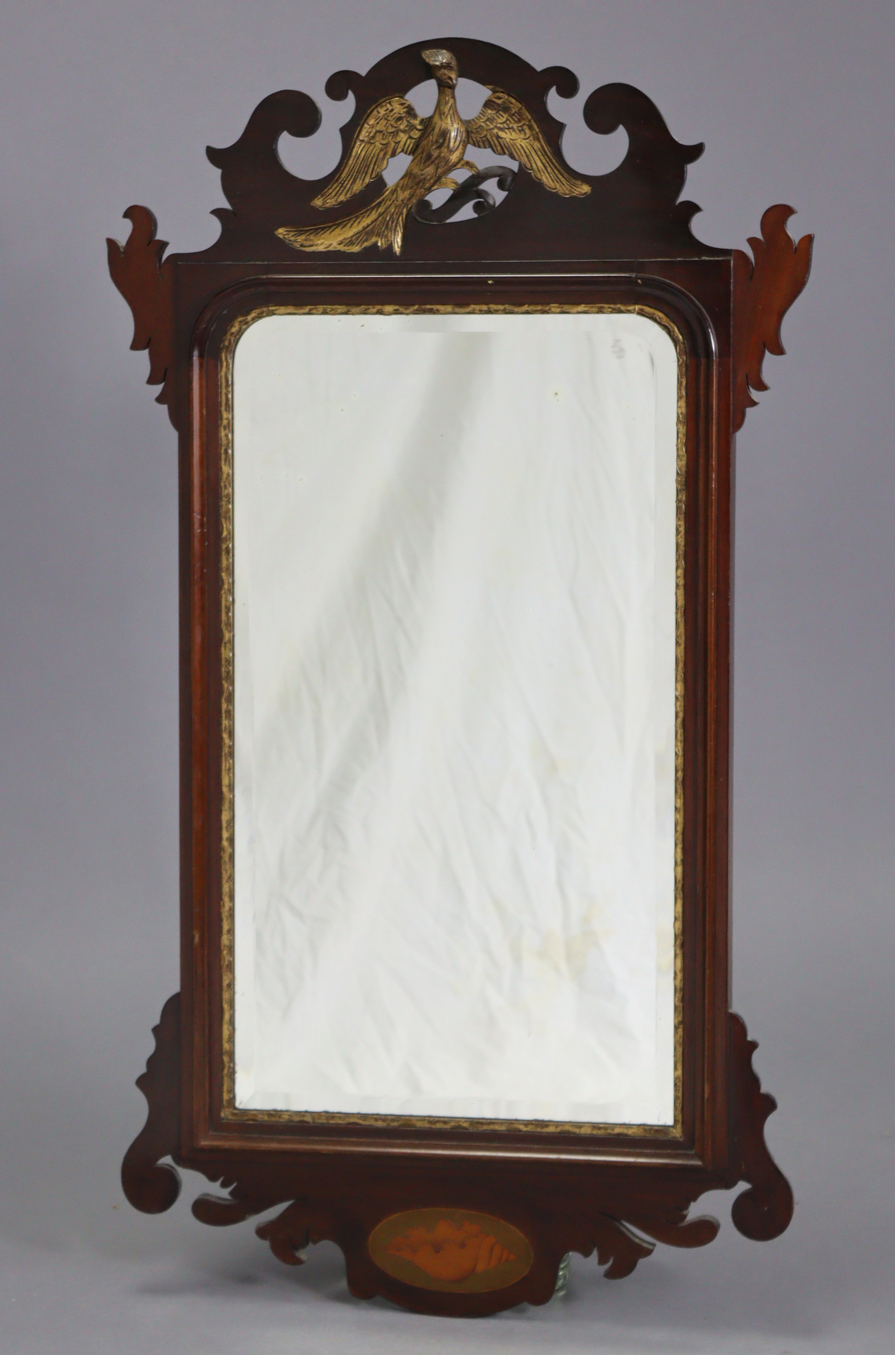 A George II-style rectangular wall mirror in fret-carved mahogany veneered frame with gilt ho-ho