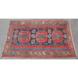 A Turkoman rug of madder ground, with multicoloured geometric decoration in multiple borders;