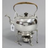 A silver-plated tea kettle of compressed round form, on spirit burner stand; 11” high.