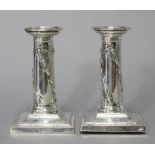 A pair of Edwardian silver desk candlesticks with beaded rims & removable drip-pans, the round