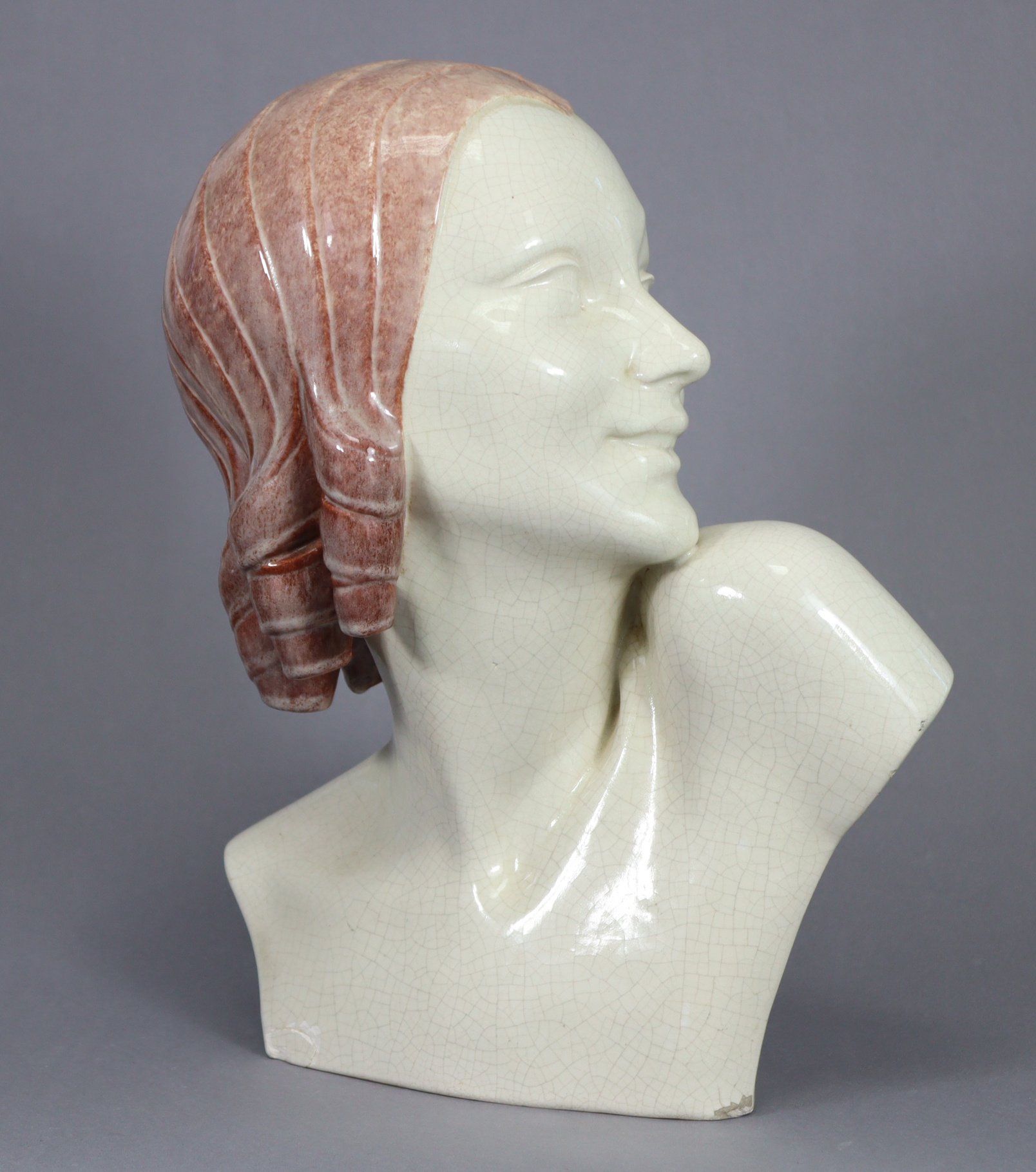 GUERO. An art Deco ceramic bust of a young woman, her head in profile turned to the left, signed